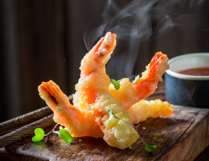 Closeup of shrimp in tempura with sour sauce and sweet