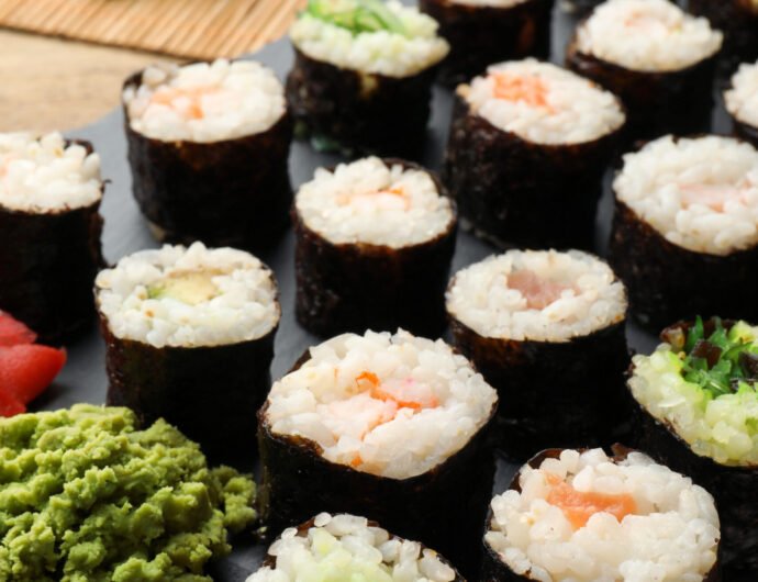 Tasty sushi rolls served on wooden table Tasty sushi rolls served on wooden table