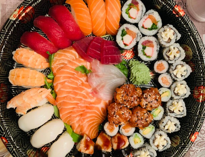 Top view of a large tray with sushi and seafood A top view of a large tray with sushi and seafood